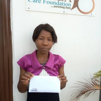 PCF Beneficiary receiving  some donation to help with her treatment .