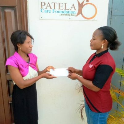 PCF Beneficiary receiving  some donation to help with her treatment .