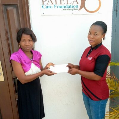 PCF Beneficiary receiving  some donation to help with her treatment .