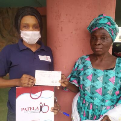 PCF Beneficiary receiving  some donation to help with her treatment .